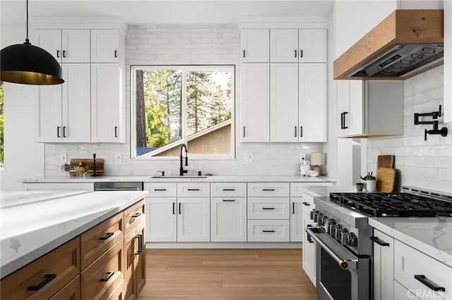 4956 Malibu Dr, Paradise, CA 95969 - kitchen featuring custom exhaust hood, high end stainless steel range oven, a sink, light stone counters, and backsplash