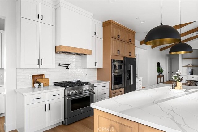 4956 Malibu Dr, Paradise, CA 95969 - kitchen with high quality appliances, tasteful backsplash, premium range hood, light wood finished floors, and light stone counters