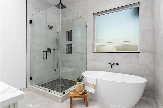 4956 Malibu Dr, Paradise, CA 95969 - bathroom featuring a soaking tub, a stall shower, and tile walls