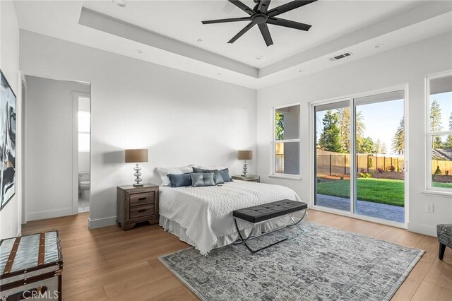 4956 Malibu Dr, Paradise, CA 95969 - bedroom with a raised ceiling, access to exterior, light wood-type flooring, and baseboards