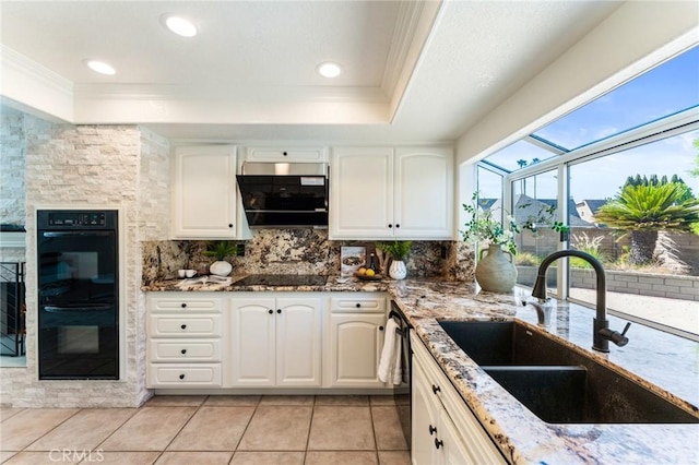 5291 Strasbourg Ave, Irvine, CA 92604 - kitchen featuring a sink, a tray ceiling, black appliances, ornamental molding, and light stone countertops