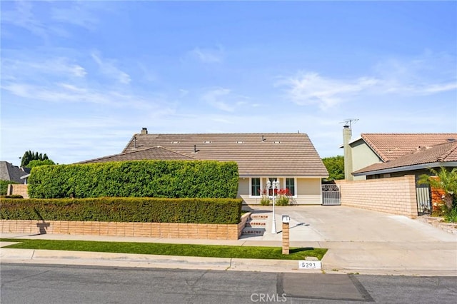 5291 Strasbourg Ave, Irvine, CA 92604 - view of front of house featuring concrete driveway, a tile roof, a gate, and a chimney
