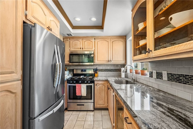 19852 Sandpiper Pl Unit 96, Newhall, CA 91321 - kitchen featuring stainless steel appliances, a tray ceiling, light brown cabinetry, stone counters, and decorative backsplash
