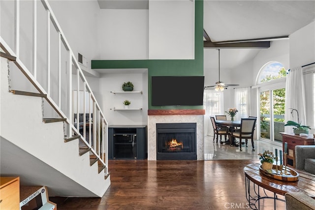 19852 Sandpiper Pl Unit 96, Newhall, CA 91321 - living room featuring stairs, wood finished floors, a tile fireplace, a high ceiling, and a ceiling fan