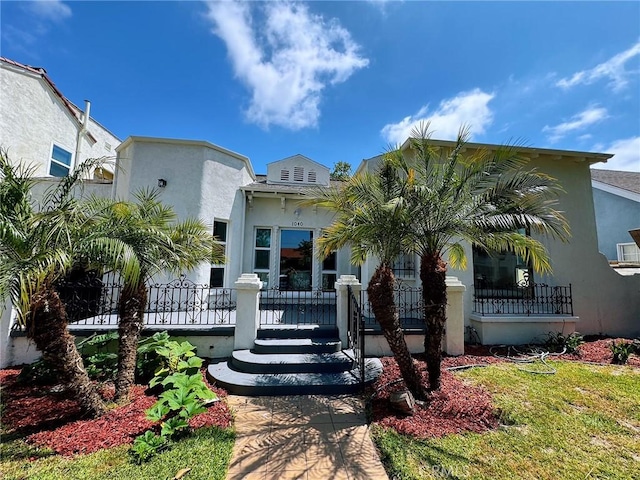 1040 W 64th St, Los Angeles, CA 90044 - mediterranean / spanish-style home with stucco siding and a wooden deck