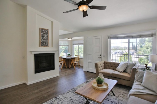 45 Via Hermosa, Rancho Santa Margarita, CA 92688 - living area featuring a fireplace, dark wood-style flooring, baseboards, and a ceiling fan