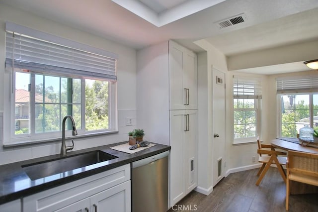 45 Via Hermosa, Rancho Santa Margarita, CA 92688 - kitchen with a sink, stainless steel dishwasher, dark countertops, dark wood-type flooring, and white cabinets