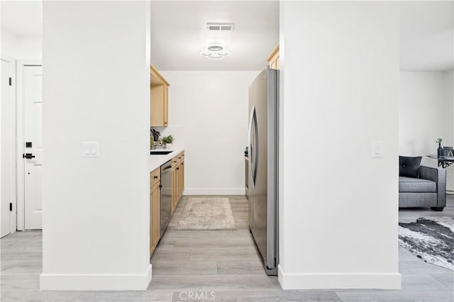 4429 Tremont St Unit 4, San Diego, CA 92102 - kitchen with stainless steel appliances, light brown cabinets, light wood-type flooring, and light countertops