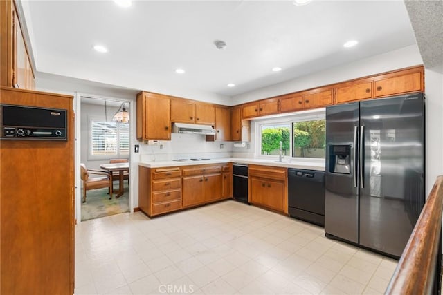 8754 Prichard St, Downey, CA 90242 - kitchen with stainless steel fridge, dishwasher, under cabinet range hood, stovetop, and light countertops