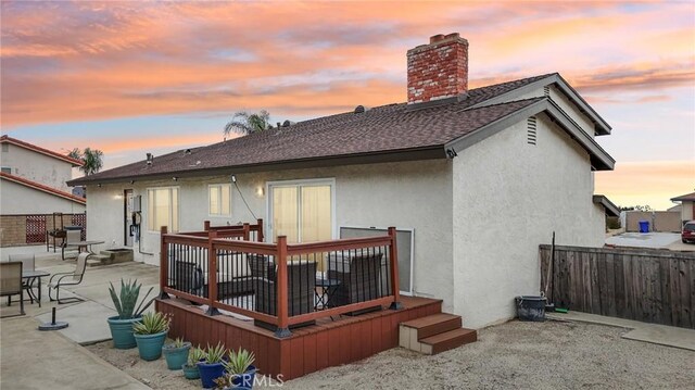 7906 Appaloosa Ct, Rancho Cucamonga, CA 91701 - back of property featuring a chimney, stucco siding, a shingled roof, a deck, and a patio area