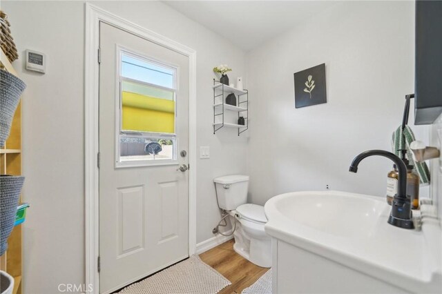 7906 Appaloosa Ct, Rancho Cucamonga, CA 91701 - half bath featuring toilet, wood finished floors, baseboards, and vanity