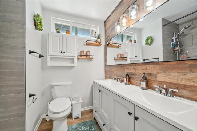 7906 Appaloosa Ct, Rancho Cucamonga, CA 91701 - full bath with toilet, double vanity, a tile shower, baseboards, and wood finished floors