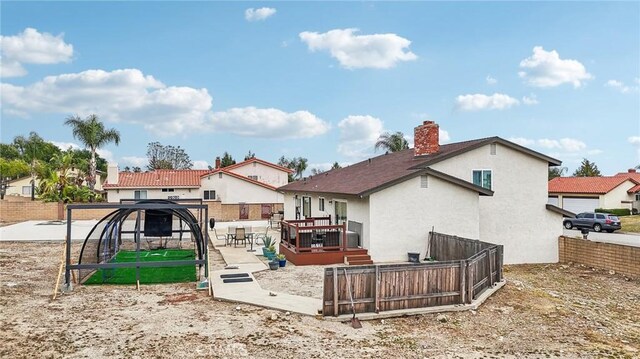 7906 Appaloosa Ct, Rancho Cucamonga, CA 91701 - back of property featuring stucco siding, a deck, and a chimney