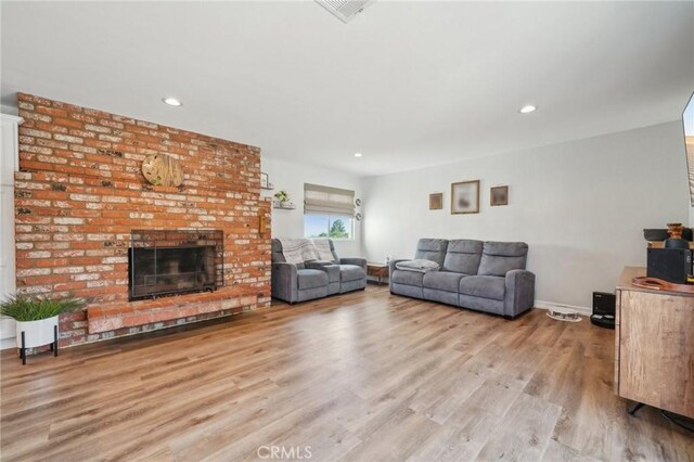 7906 Appaloosa Ct, Rancho Cucamonga, CA 91701 - living area featuring light wood-style floors, a fireplace, recessed lighting, and baseboards