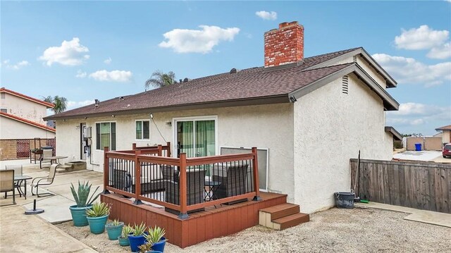 7906 Appaloosa Ct, Rancho Cucamonga, CA 91701 - back of house with stucco siding, a shingled roof, a chimney, a deck, and a patio