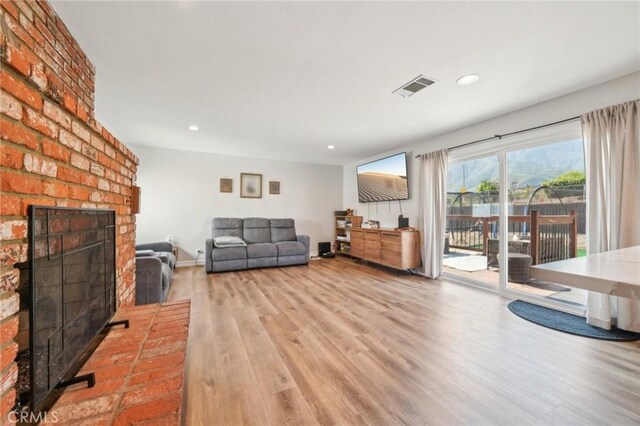 7906 Appaloosa Ct, Rancho Cucamonga, CA 91701 - living area featuring wood finished floors, a fireplace, recessed lighting, and baseboards