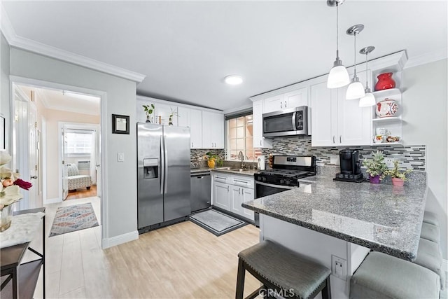 20402 Pioneer Blvd, Lakewood, CA 90715 - kitchen with appliances with stainless steel finishes, crown molding, a peninsula, white cabinets, and backsplash