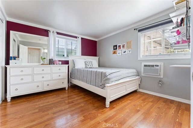 20402 Pioneer Blvd, Lakewood, CA 90715 - bedroom with light wood finished floors, crown molding, a wall unit AC, and baseboards