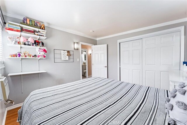 20402 Pioneer Blvd, Lakewood, CA 90715 - bedroom with wood finished floors, crown molding, a closet, and baseboards