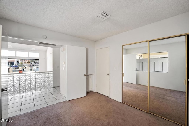 4320 Meridian Ave, Oxnard, CA 93035 - unfurnished bedroom featuring carpet flooring, a textured ceiling, and tile patterned floors