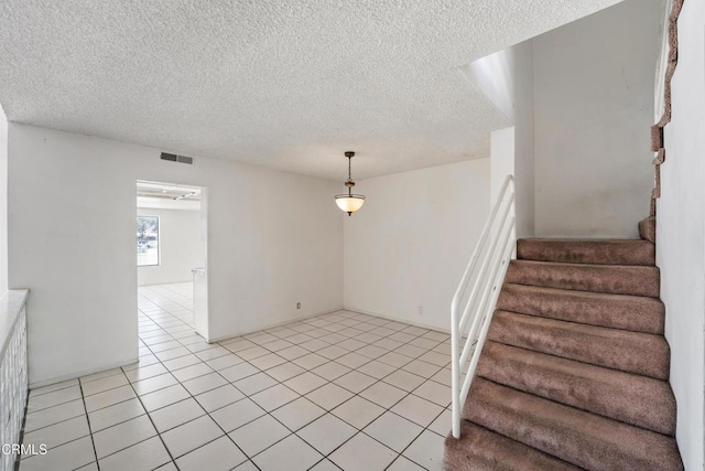 4320 Meridian Ave, Oxnard, CA 93035 - stairs with a textured ceiling and tile patterned floors