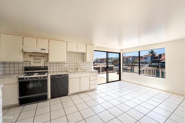4320 Meridian Ave, Oxnard, CA 93035 - kitchen featuring dishwasher, gas range gas stove, under cabinet range hood, backsplash, and tile counters