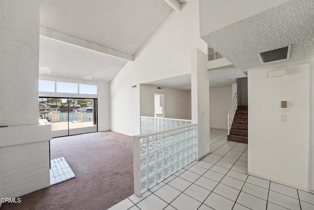 4320 Meridian Ave, Oxnard, CA 93035 - empty room with high vaulted ceiling, beam ceiling, light colored carpet, a textured ceiling, and light tile patterned floors