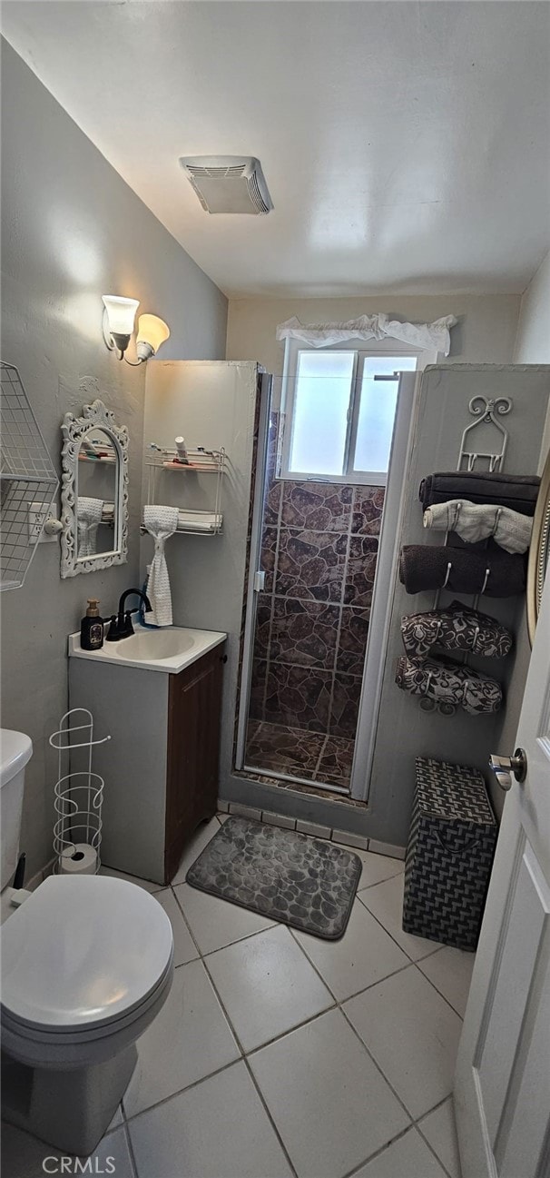 450 W D St, Colton, CA 92324 - bathroom with toilet, vanity, a shower stall, and tile patterned flooring