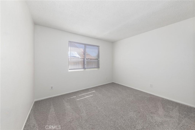 4231 Sage Ct, Palmdale, CA 93552 - unfurnished room featuring carpet, a textured ceiling, and baseboards