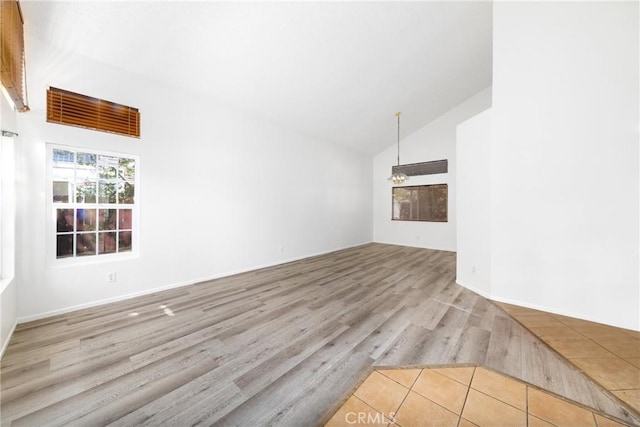 4231 Sage Ct, Palmdale, CA 93552 - unfurnished living room with vaulted ceiling and wood finished floors