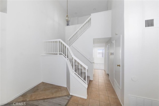 4231 Sage Ct, Palmdale, CA 93552 - stairs with tile patterned floors and a towering ceiling