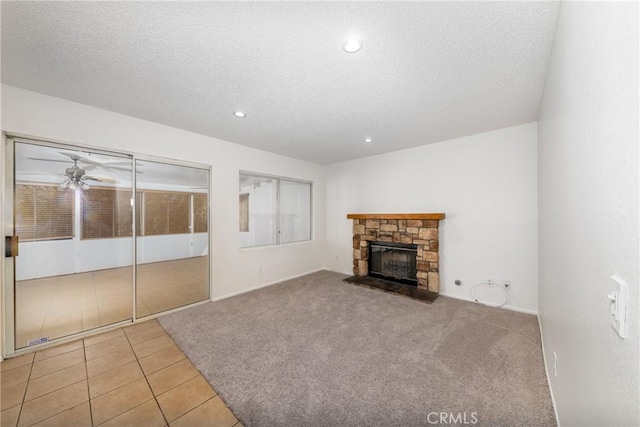 4231 Sage Ct, Palmdale, CA 93552 - unfurnished living room with a textured ceiling, a stone fireplace, recessed lighting, tile patterned flooring, and a ceiling fan