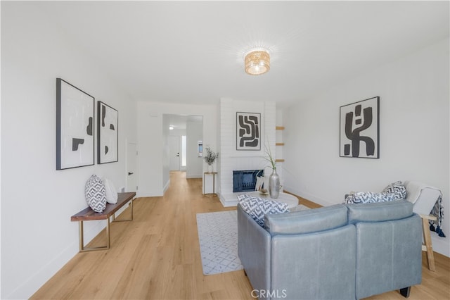 676 N 12th St Unit 21, Grover Beach, CA 93433 - living area featuring baseboards, light wood finished floors, and a fireplace