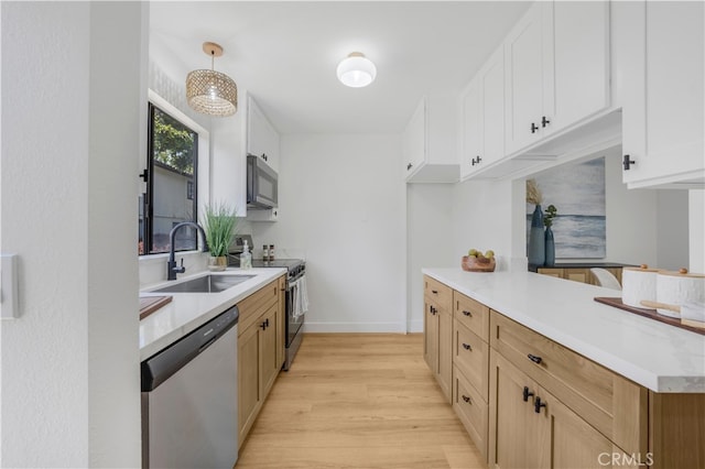 676 N 12th St Unit 21, Grover Beach, CA 93433 - kitchen with appliances with stainless steel finishes, a sink, light wood-style floors, light countertops, and baseboards
