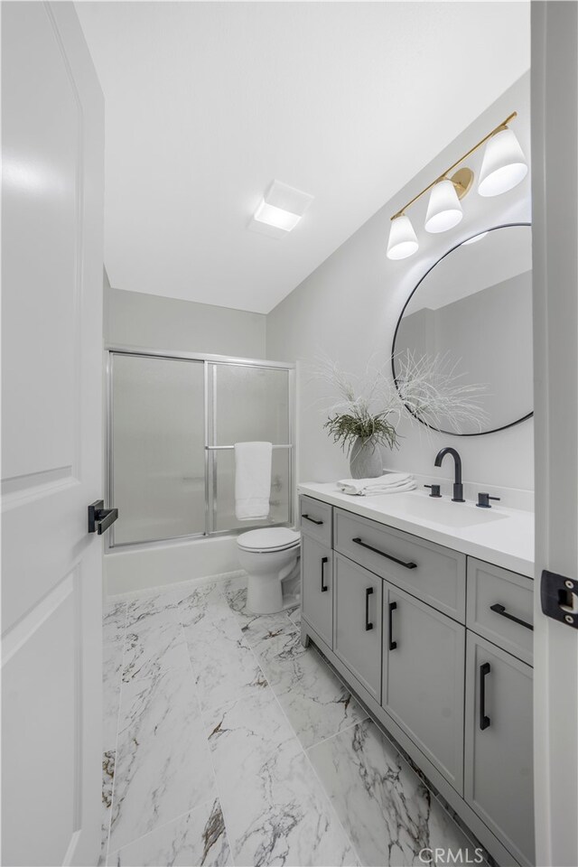 676 N 12th St Unit 21, Grover Beach, CA 93433 - bathroom with vanity, bath / shower combo with glass door, marble finish floors, and toilet