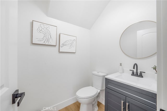 676 N 12th St Unit 21, Grover Beach, CA 93433 - bathroom with vanity, toilet, wood finished floors, baseboards, and vaulted ceiling