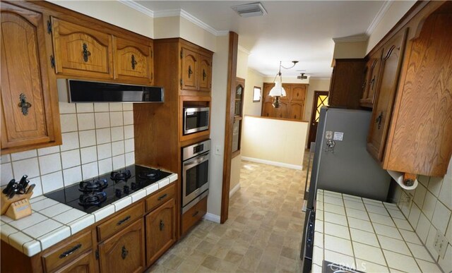 11514 Beverly Blvd, Whittier, CA 90601 - kitchen featuring stainless steel appliances, tile countertops, extractor fan, brown cabinetry, and ornamental molding