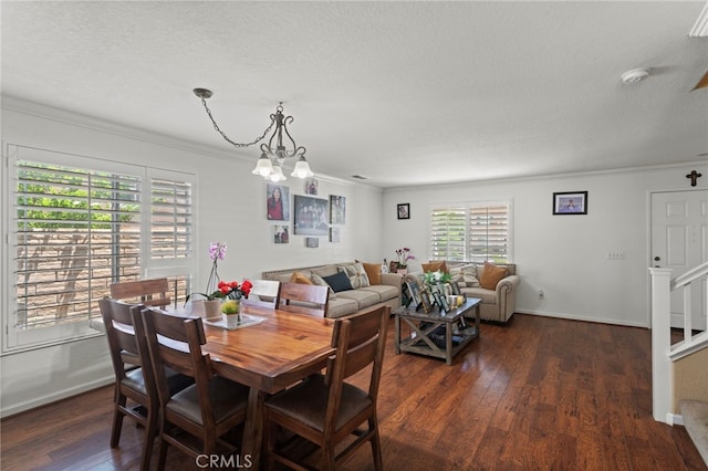 38701 Annette Ave, Palmdale, CA 93551 - dining area featuring ornamental molding, dark wood-style flooring, a textured ceiling, a chandelier, and baseboards