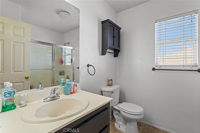 38701 Annette Ave, Palmdale, CA 93551 - full bath with toilet, a stall shower, vanity, tile patterned flooring, and baseboards