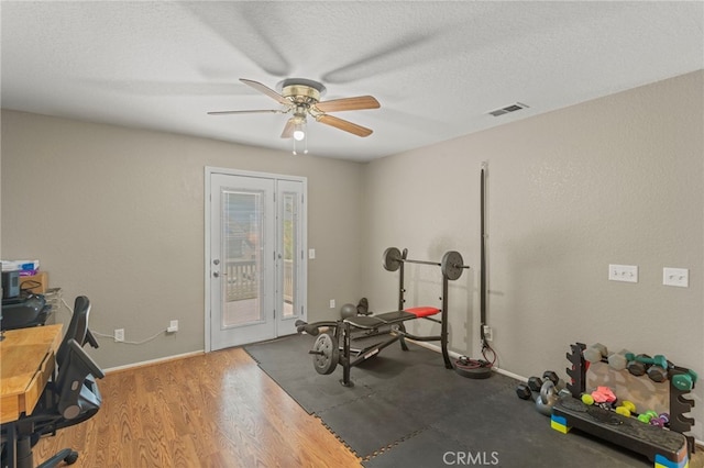 38701 Annette Ave, Palmdale, CA 93551 - workout area with a ceiling fan, baseboards, a textured ceiling, and wood finished floors