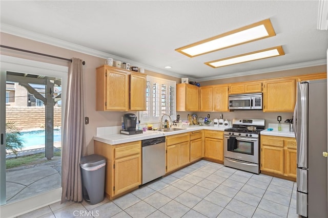 38701 Annette Ave, Palmdale, CA 93551 - kitchen featuring appliances with stainless steel finishes, a sink, ornamental molding, light tile patterned floors, and tile counters