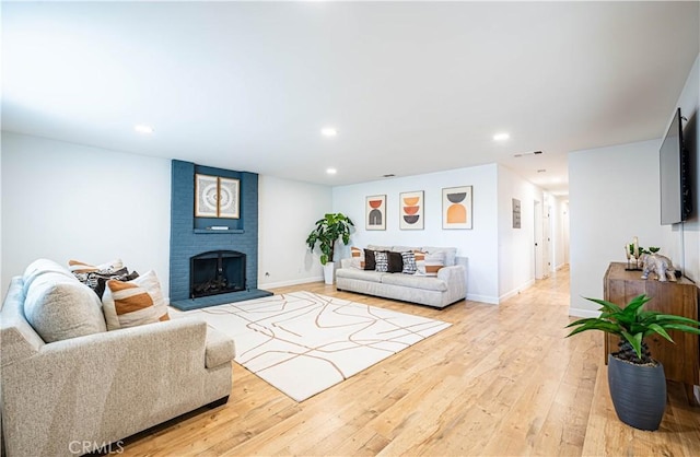 7017 Filkins Ave, Rancho Cucamonga, CA 91701 - living area featuring recessed lighting, light wood-type flooring, baseboards, and a fireplace