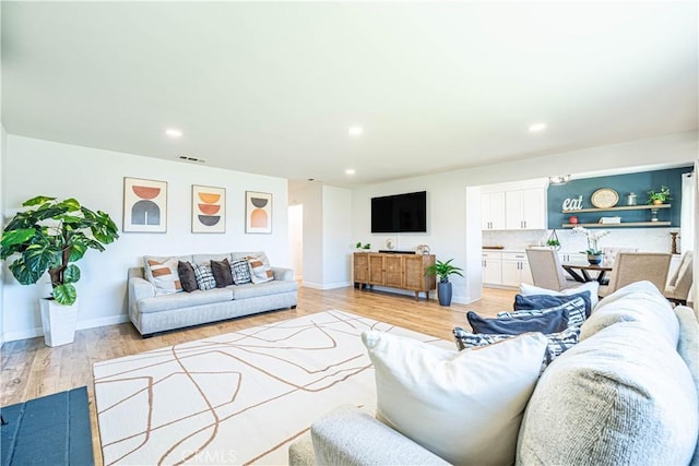 7017 Filkins Ave, Rancho Cucamonga, CA 91701 - living room featuring recessed lighting, light wood-type flooring, and baseboards