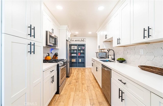 7017 Filkins Ave, Rancho Cucamonga, CA 91701 - kitchen with appliances with stainless steel finishes, light wood finished floors, white cabinetry, light countertops, and recessed lighting