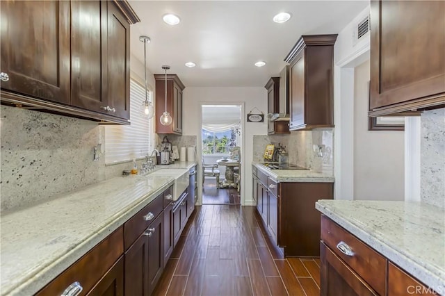 4508 Don Timoteo Dr, Los Angeles, CA 90008 - kitchen with tasteful backsplash, light stone countertops, dark wood-type flooring, hanging light fixtures, and recessed lighting