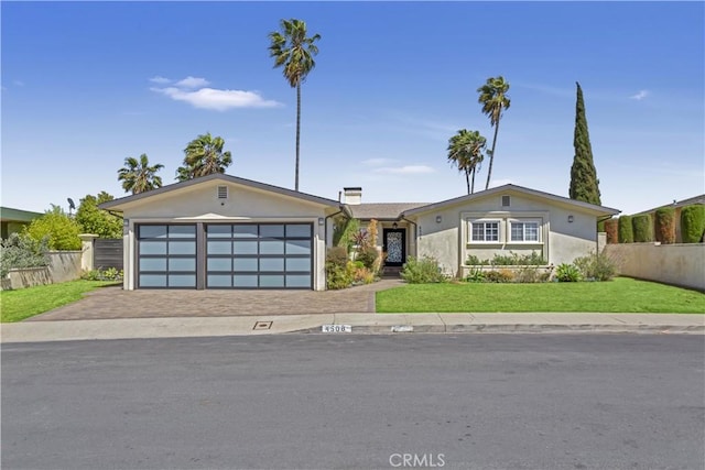 4508 Don Timoteo Dr, Los Angeles, CA 90008 - view of front of house with a garage, driveway, and stucco siding
