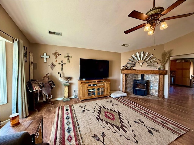 9307 Banderilla Dr, La Grange, CA 95329 - living area with wood finished floors, a ceiling fan, a wood stove, baseboards, and lofted ceiling