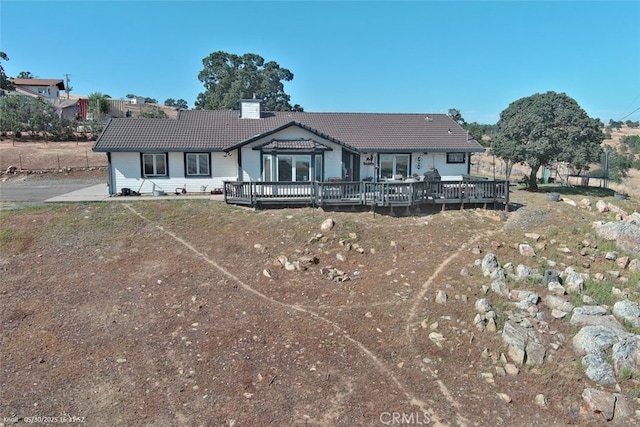9307 Banderilla Dr, La Grange, CA 95329 - view of front facade with a tile roof, a wooden deck, and a chimney