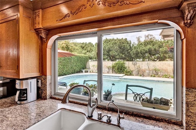 3595 Sego St, Irvine, CA 92606 - kitchen view of a sink, brown cabinetry, and decorative backsplash