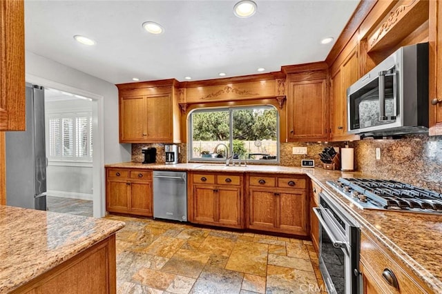 3595 Sego St, Irvine, CA 92606 - kitchen featuring stainless steel appliances, a sink, brown cabinets, backsplash, and recessed lighting